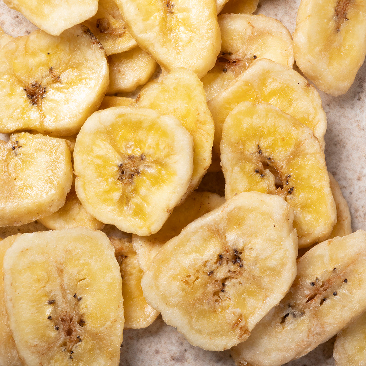 Organic sweetened dried banana chips from Whole Food Earth, showing golden banana slices with a natural, textured appearance.