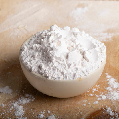 Organic tapioca starch in a clear bowl, showing fine white powder, from Whole Food Earth, used as a gluten-free flour alternative.
