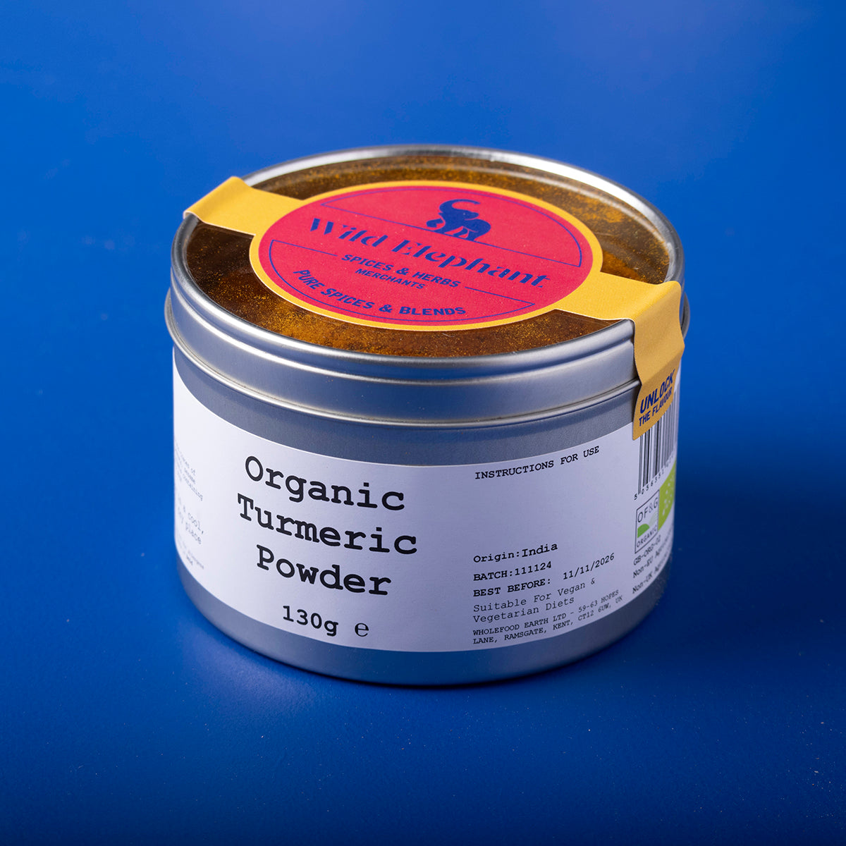 Organic turmeric powder in a clear jar from Whole Food Earth, showing bright yellow spice in a natural setting.