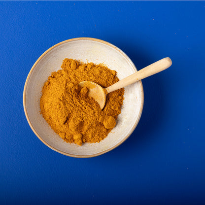 Organic turmeric powder by Wild Elephant in a 130g package, showcasing bright yellow powder in a natural herbs and spices setting.
