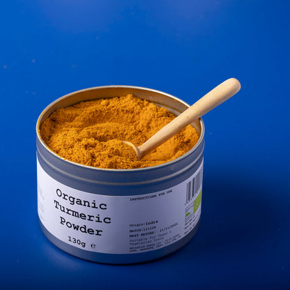 Organic turmeric powder in a clear container, labeled with Wild Elephant brand, showing bright yellow spice from Whole Food Earth.