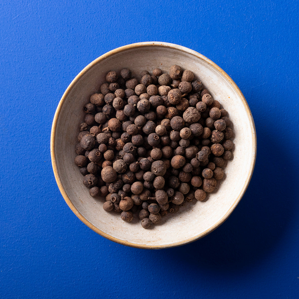 Organic whole allspice berries from Wild Elephant, 80g, in a jar, showcasing the natural spice used in cooking and baking.