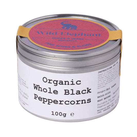 Organic Whole Black Peppercorns from Wild Elephant, Whole Food Earth herbs and spices in a clear jar showing black peppercorns.