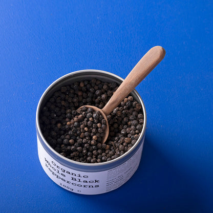 Organic Whole Black Peppercorns from Wild Elephant by Whole Food Earth, showing fresh, whole black peppercorns in a natural setting.