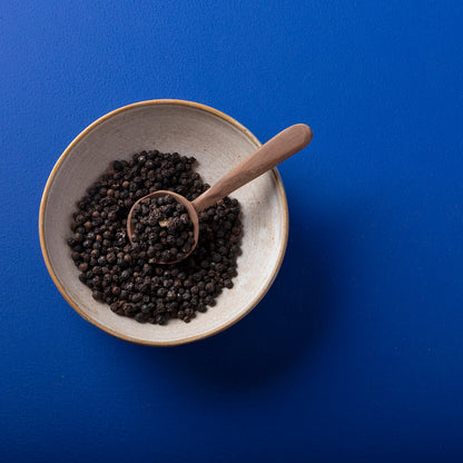 Organic Whole Black Peppercorns from Wild Elephant, herbs and spices by Whole Food Earth, shown in a close-up image.