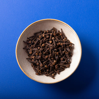 Organic Whole Cloves from Wild Elephant, 80g, in a jar, showing dark brown aromatic spice used in cooking and baking.
