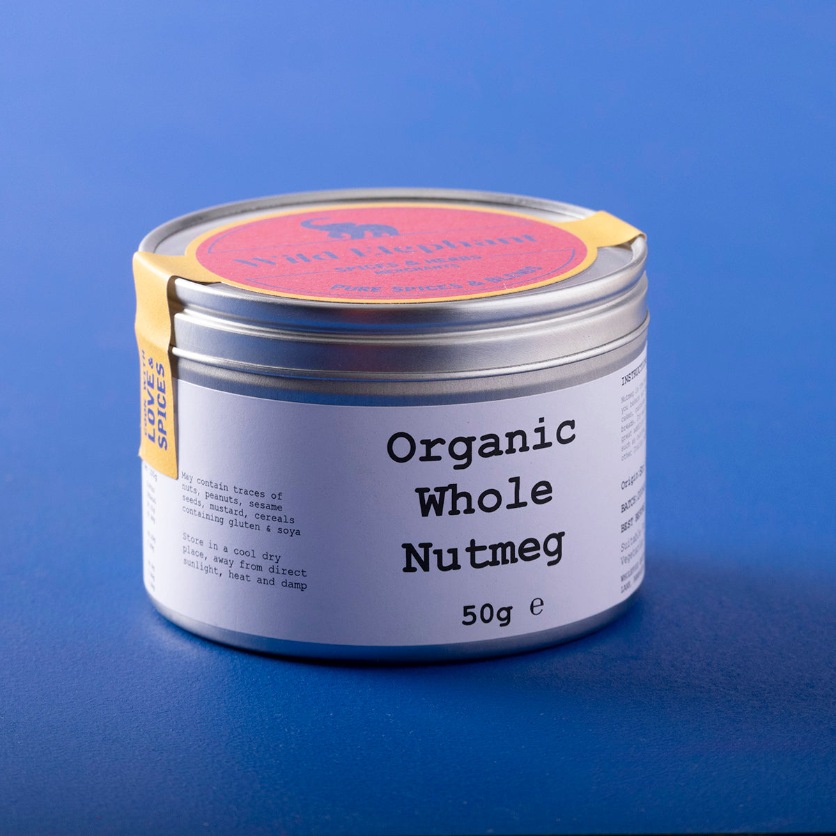 Organic whole nutmeg from Wild Elephant, displayed in a clear container, showcasing the brown, textured spice on a white background.