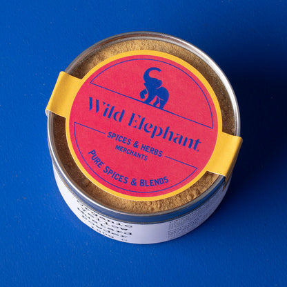 Organic yellow mustard powder from Wild Elephant in a 150g package, showing vibrant yellow spice in a clear jar.