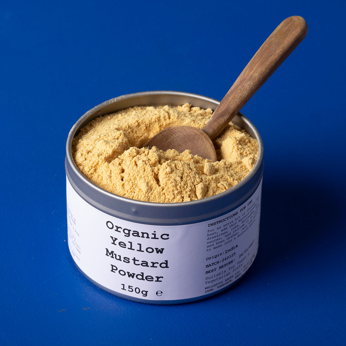 Organic yellow mustard powder from Whole Food Earth, in a 150g package, showing bright yellow spice in a clear container.
