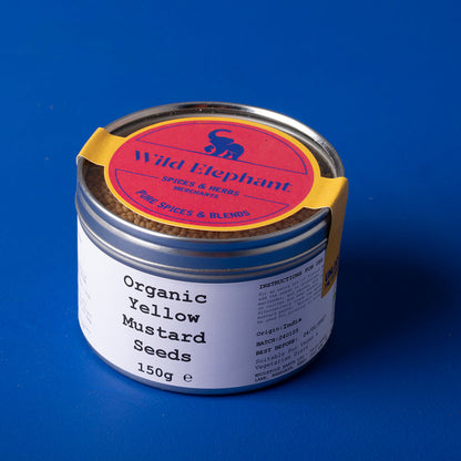 Organic yellow mustard seeds from Wild Elephant, 150g, shown in a clear image, highlighting fresh herbs and spices.
