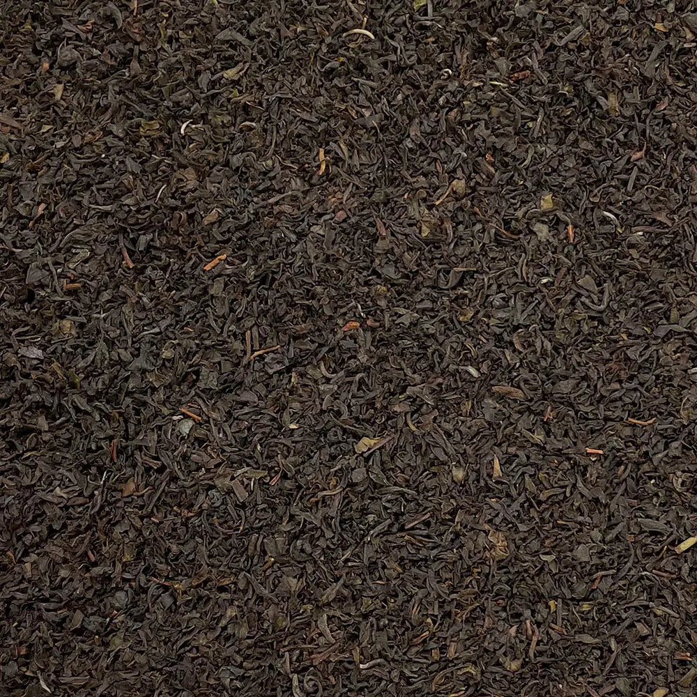 Loose leaf Nilgiri Blue Mountain SFTGFOP1 tea by High Teas, showcasing vibrant blue-tipped tea leaves in a clear jar.