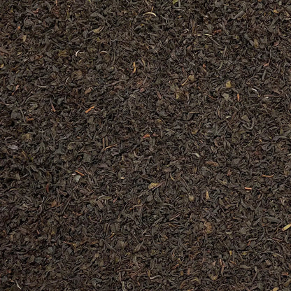 Loose leaf Nilgiri Blue Mountain SFTGFOP1 tea by High Teas, showcasing vibrant blue-tipped tea leaves in a clear jar.