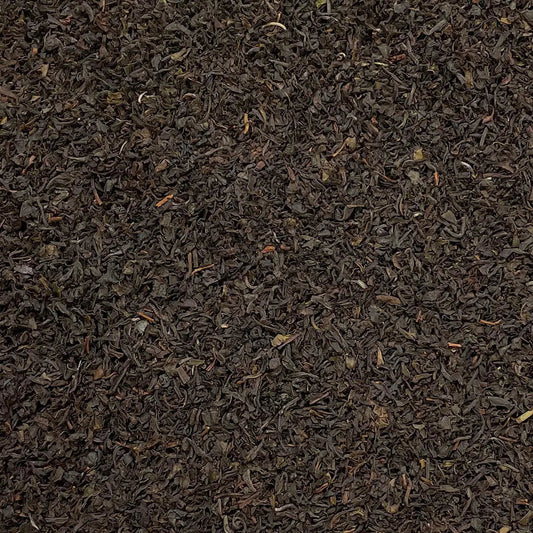 Loose leaf Nilgiri Blue Mountain SFTGFOP1 tea from High Teas, showcasing premium, aromatic tea leaves in a natural setting.