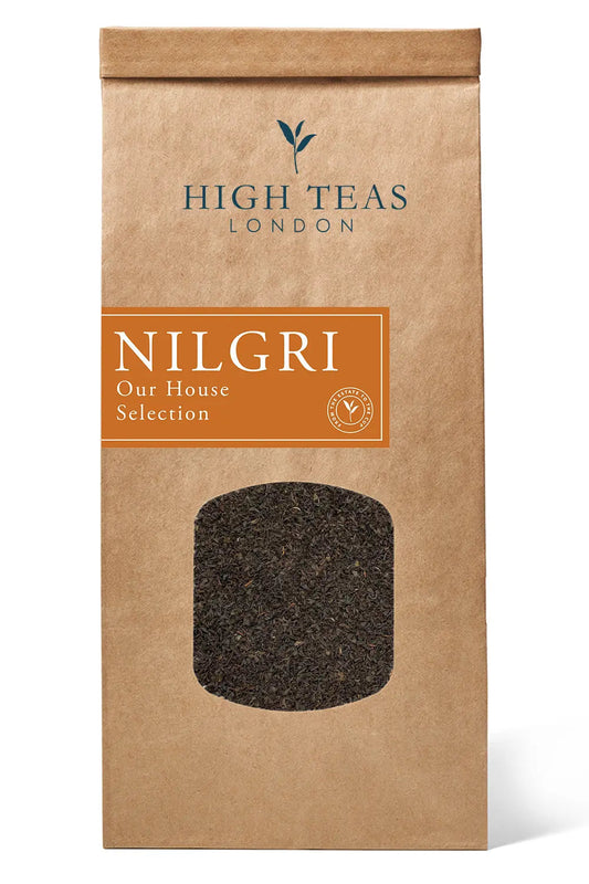 High Teas Nilgiri Blue Mountain SFTGFOP1 loose leaf tea in a tin, showcasing dark green tea leaves from the Our House Selection.