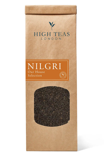 Loose leaf Nilgiri Blue Mountain SFTGFOP1 tea from High Teas, showcasing vibrant blue-green tea leaves in a clear container.
