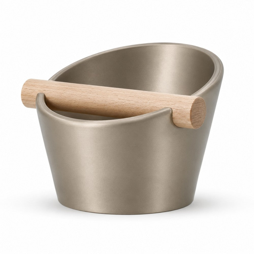 KNOCDIC® oval coffee knock box with metallic gold finish and real oak wood bar for espresso machine tamping.