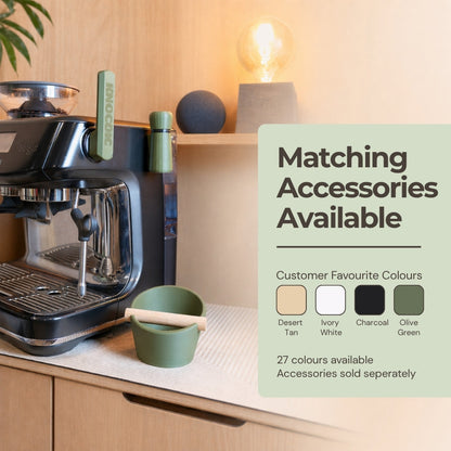 KNOCDIC® WDT tool with magnetic holder, shown with matching colorful oval knockbox in a professional coffee setup.