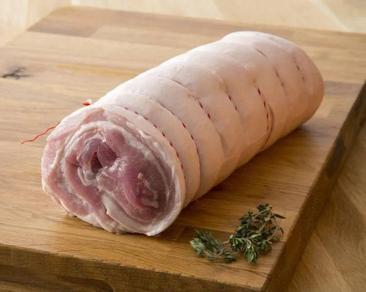 Boneless pork belly joint from Primrose Herd, showcasing fresh, well-trimmed pork belly with a pink hue and smooth fat layer.