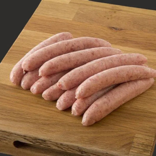 Primrose Herd chipolata sausages, raw and uncooked, shown in black background, ready for cooking or grilling.
