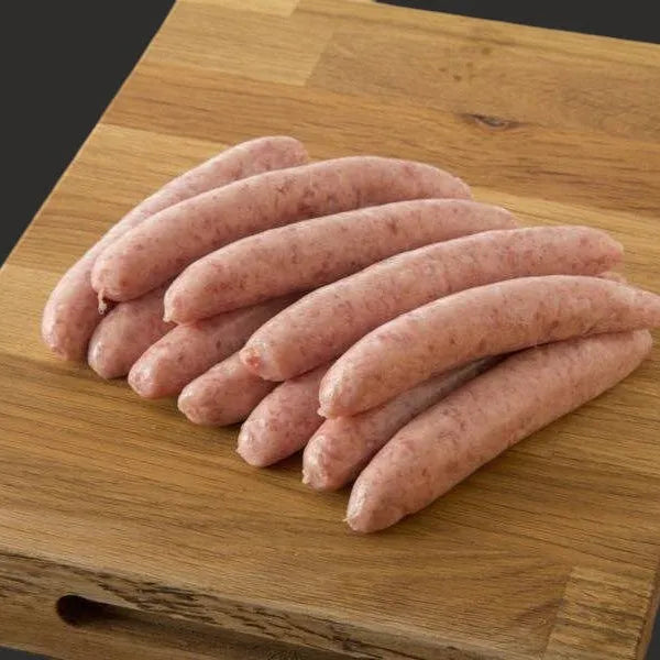 Primrose Herd Cornish outdoor-reared pork sage and onion chipolatas sausages on a plate, ready to cook.
