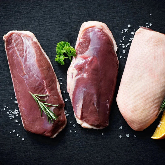 Primrose Herd Creedy Carver free-range duck breasts, raw and fresh with skin and meat visible on each piece.