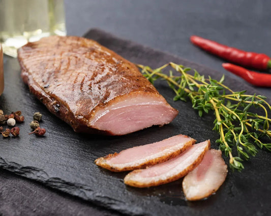 Raw Creedy Carver free-range duck breasts from Primrose Herd, showing fresh, skin-on duck meat with a deep red color and crispy skin.