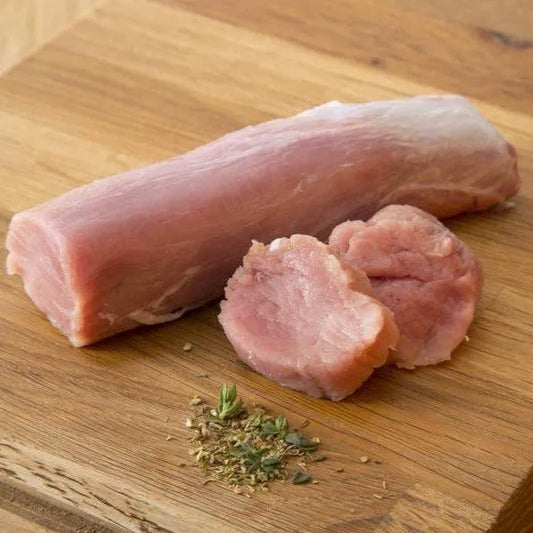 Fresh Primrose Herd pork tenderloin raw meat on a cutting board, ready for cooking