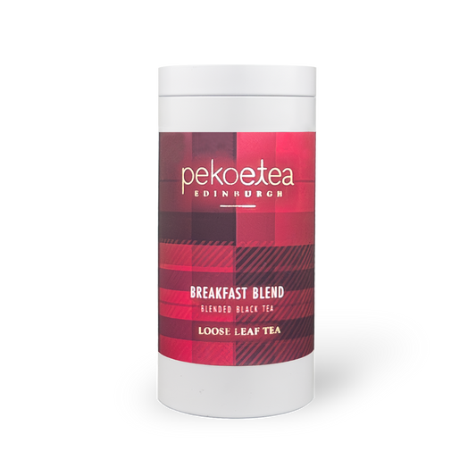 PekoeTea Edinburgh Breakfast Blend tea in a decorative caddy, showcasing the tea packaging with a close-up of the label.