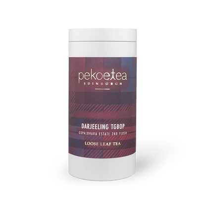 Pekoetea Edinburgh Gopaldhara TGBOP Second Flush Darjeeling tea in a metal caddy with tea leaves and packaging details visible
