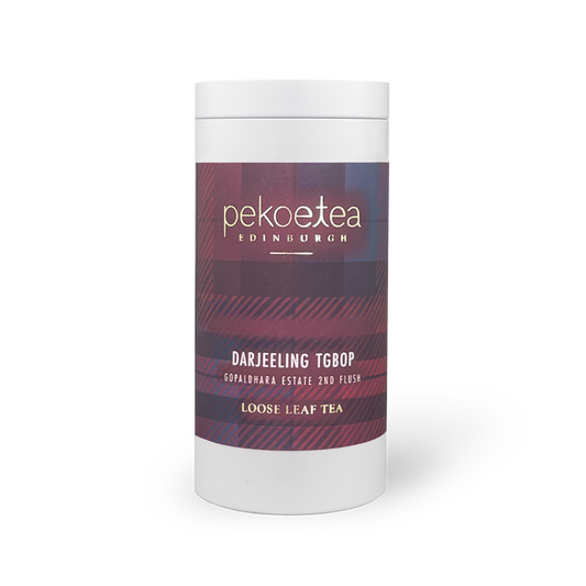 Pekoetea Edinburgh Gopaldhara TGBOP Second Flush Darjeeling tea in a metal caddy with tea leaves and packaging details visible