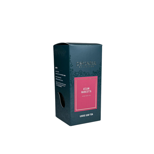 Box of PekoeTea Edinburgh Mancotta Assam tea, featuring a colorful packaging design with tea leaves and branding.