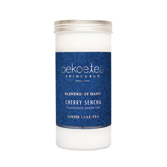 Cherry Sencha green tea in a PekoeTea Edinburgh caddy, featuring fresh cherry and green tea leaves in a decorative tin.