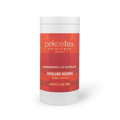 PekoeTea Edinburgh Highland Rooibos tea in a decorative caddy, featuring dried rooibos leaves and packaging with Scottish Highland imagery.