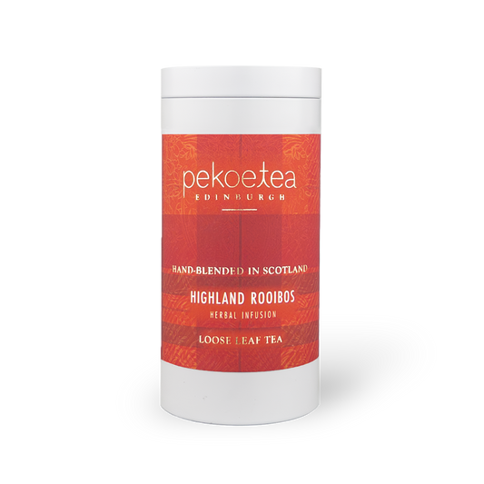 PekoeTea Edinburgh Highland Rooibos tea in a decorative caddy, featuring dried rooibos leaves and a rustic label.