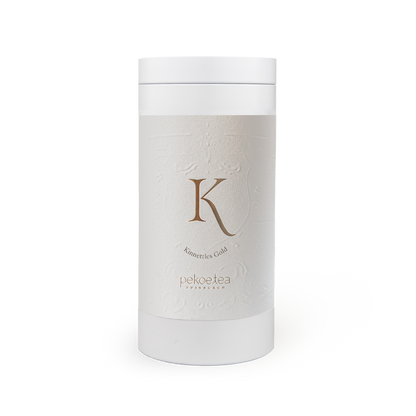 PekoeTea Edinburgh Kinnettles Gold Scottish Grown Tea in a decorative gold tin caddy with tea leaves inside.
