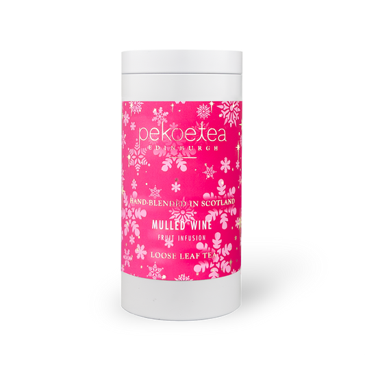 PekoeTea Edinburgh mulled wine tea in a decorative caddy, showcasing dried tea leaves and spices for flavorful brewing.
