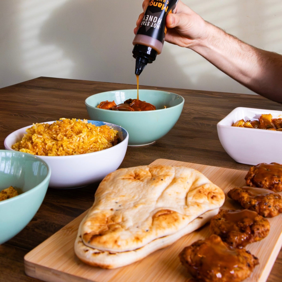 Hot Star Honey Hot Honey Sauce Trio gift set with mango and curry flavors, showcasing colorful bottles and vibrant packaging.