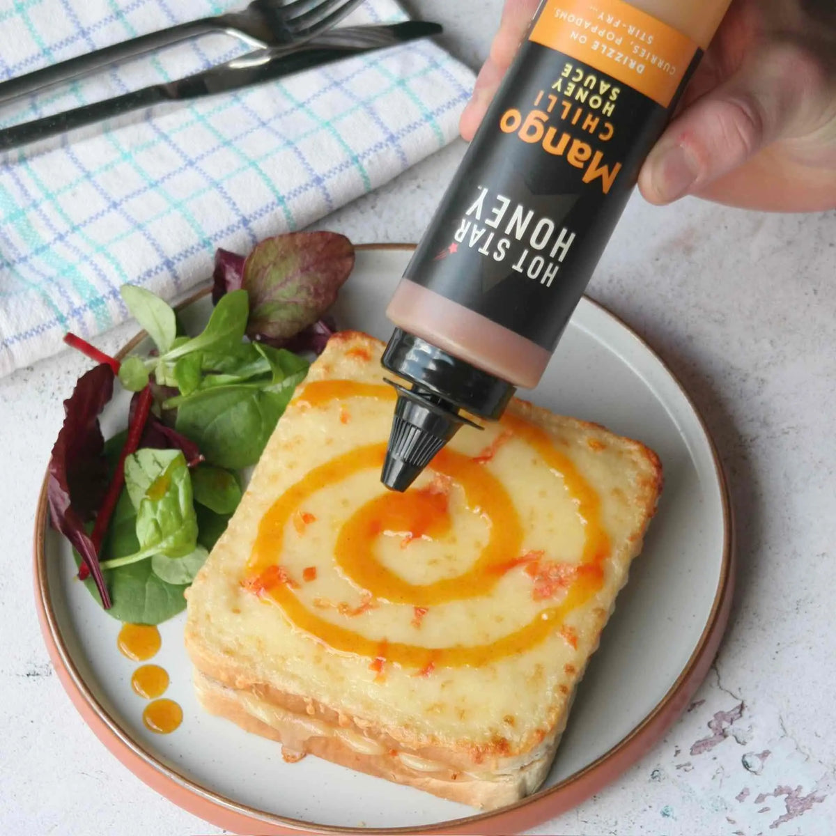 Asian-inspired Mango Chilli Honey Sauce drizzled on toast, featuring ripe mango slices and a spicy chili honey glaze.