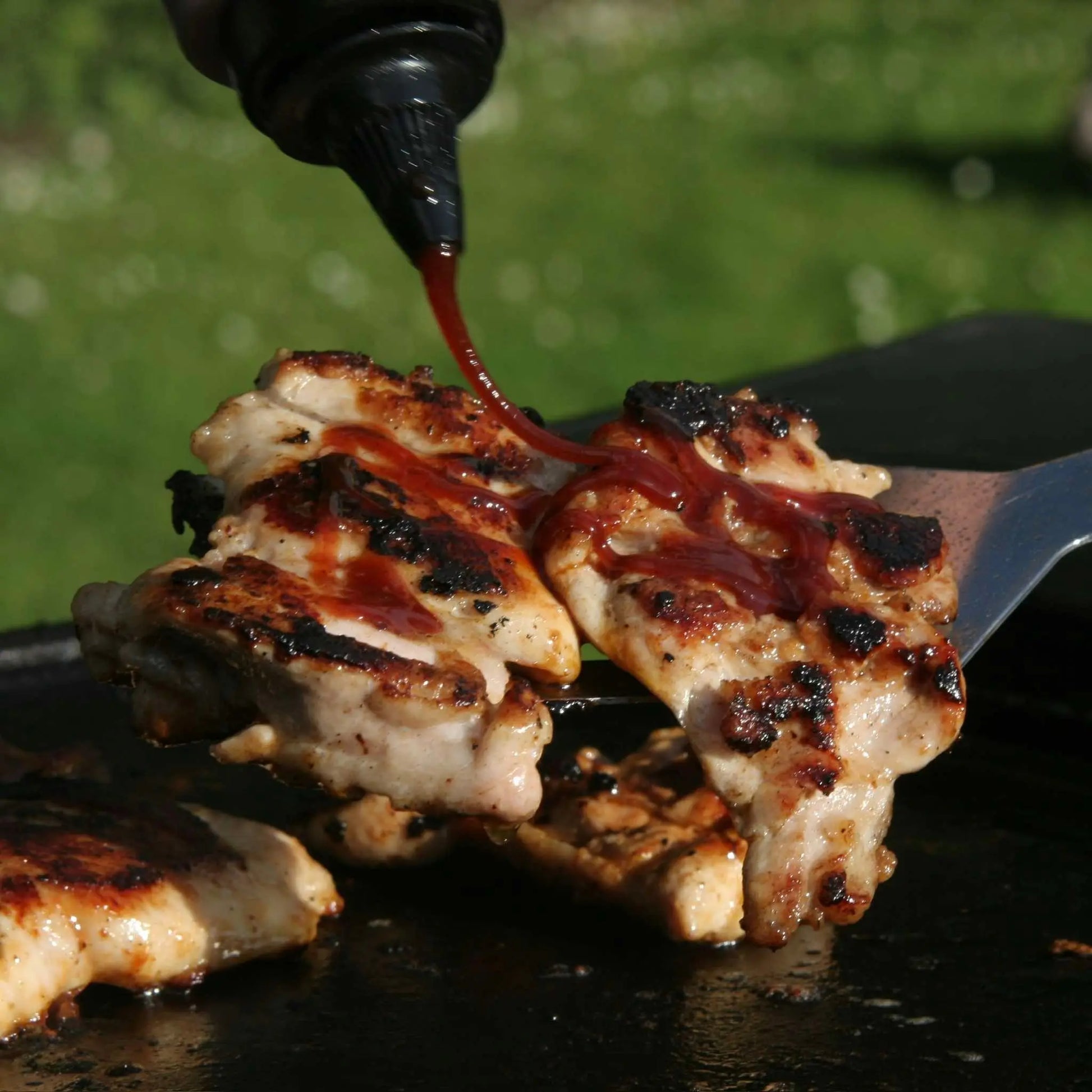 Korean BBQ chicken glazed with Hot Star Honey BBQ Sauce, showcasing a shiny, flavorful coating on grilled chicken pieces.