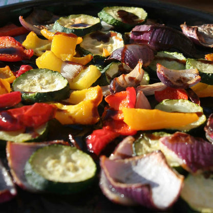 Hot Star Honey Balsamic Glaze Trio gift set displayed with roasted vegetables drizzled with balsamic glaze.
