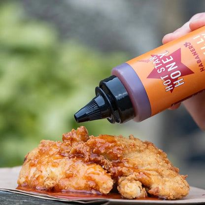Spicy Habanero hot chilli honey drizzled on cooked chicken, showcasing the Hot Star Honey brand's chili-infused honey flavor.