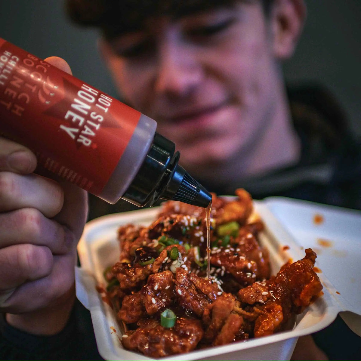 Scotch Bonnet Chilli Honey by Hot Star Honey drizzled over grilled chicken, showing vibrant chili and honey glaze.