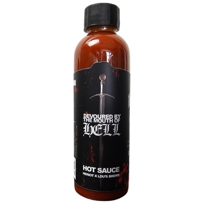 Hot sauce bottle from Lou's Brews, featuring Lou's x Heriot x Kerrang Devoured By The Mouth Of Hell Hot Sauce, with fiery label design.