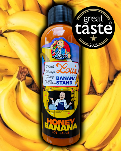 Bottle of Lou's Brews banana and honey sauce, a condiment with banana and honey flavors, in a clear glass container.