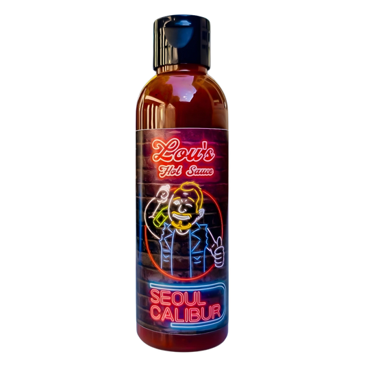 Seoul Calibur Kimchi Hot Sauce bottle by Lou's Brews, spicy condiment with vibrant label, in a condiment bottle on a white background.