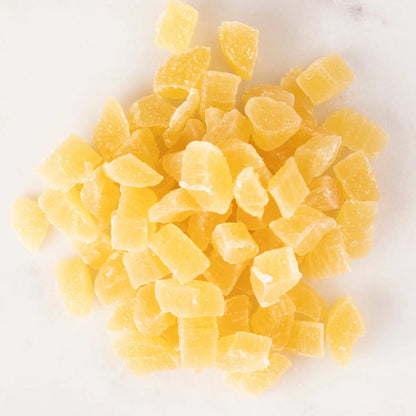 Dried pineapple dices from Whole Food Earth, showing bright yellow, cubed dried fruit on a white background.
