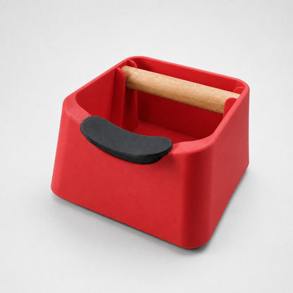 Red KNOCDIC® Pod 3-in-1 espresso knock box with portafilter stand and oak wood knock bar for coffee grounds disposal.