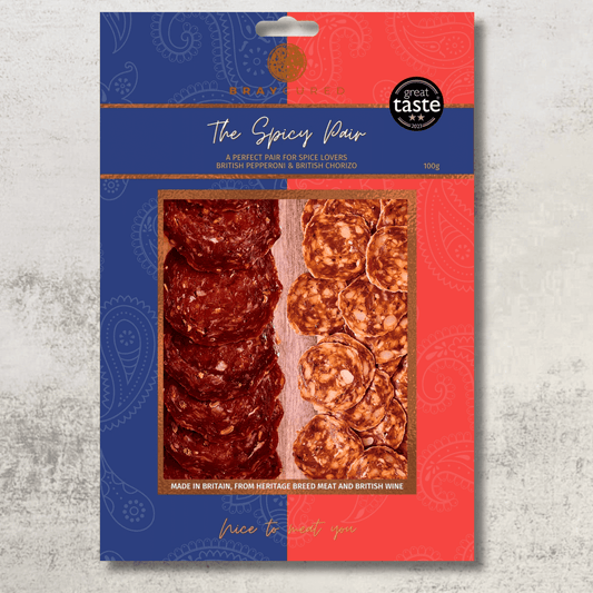 Assorted spicy charcuterie selection featuring cured meats from Bray Cured, arranged on a wooden board.