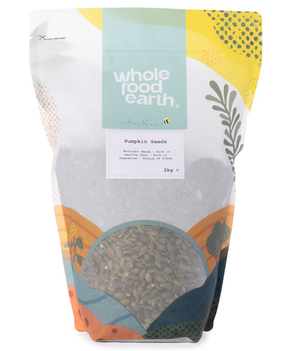 Two kilograms of Whole Food Earth pumpkin seeds, showing fresh, green seeds in a clear container for nuts and seeds.