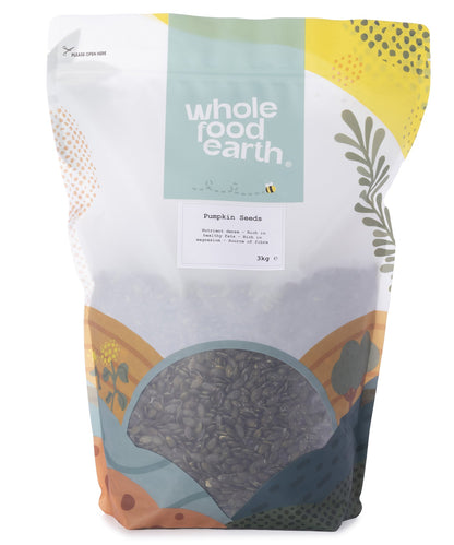 Whole Food Earth pumpkin seeds, 3kg package, close-up of roasted pumpkin seeds with green shells and textured surface.